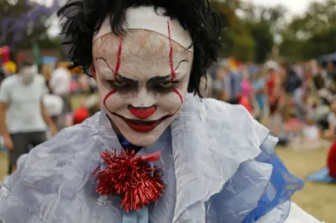 EPA A child wears a costume during the annual Halloween party at the George Hay Park in Johannesburg, South Africa, 31 October 2018. Hundreds of local residents gather at the park in the evening to dress up, trick-or-treat and have a best dressed competition. Halloween has its roots in an ancient, pre-Christina Celtic festival named Samhain. The Celts lived 2,000 years ago and believed that the dead returned to Earth on the Samhain festival.