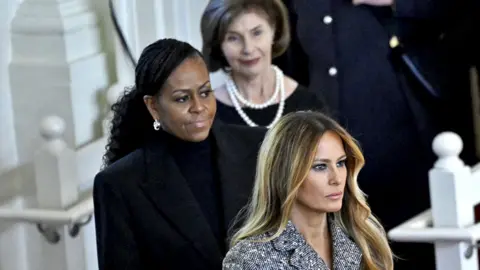 Former US First Lady Laura Bush, former US First Lady Michelle Obama, and former US First Lady Melania Trump arrive for a tribute service for former US First Lady Rosalynn Carter, at Glenn Memorial Church in Atlanta, Georgia, on November 28, 2023