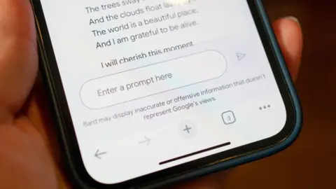 Getty Images Person's hand holding an iPhone displaying Google's Bard AI chatbot with prompt entry field