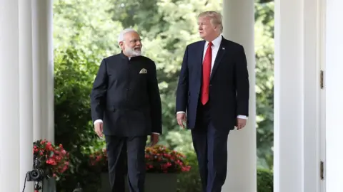 Getty Images President Donald Trump and Indian Prime Minister Narendra Modi walk to deliver statements at the White House June 2017