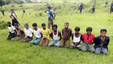 HANDOUT The 10 Rohingya men before they were killed at Inn Din