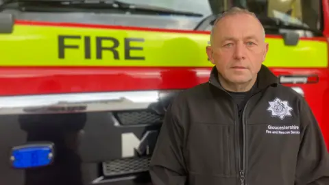 BBC Ian Shoemark next to a fire engine