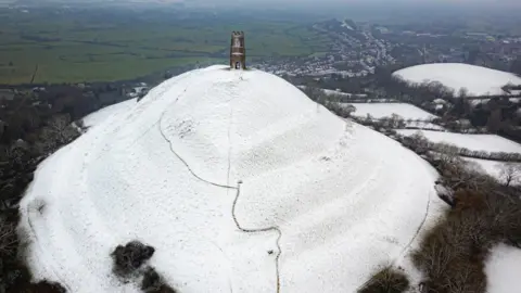 PA Media Snow settles on Glastonbury Tor in Somerset