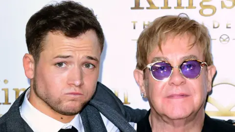 PA Taron Egerton (left) and Sir Elton John