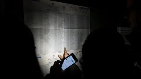 Reuters A voter looks at a electoral list during a blackout in Argentina