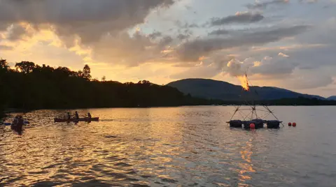 Mike Hyde Meanwhile 1st Helensburgh Scout Group lit a floating beacon on Loch Lomond