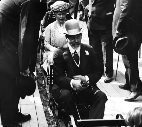 Getty Images Black and white photo of King George V and Queen Mary riding a miniature train