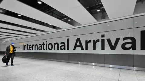 Getty Images Passengers arrive with at the Terminal 5 international arrivals hall at London Heathrow Airport