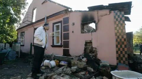 EPA A local man inspects a damaged building following an explosion at a ammunition depot in Kalynivka city, not far from Vinnytsia on 27 Sept