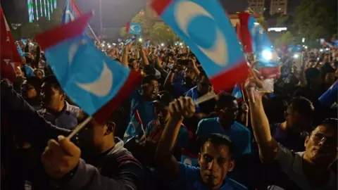 AFP Supporters wave the party"s flag at the jailed former opposition leader and current federal opposition leader Anwar Ibrahim in Kuala Lumpur on May 16, 2018.