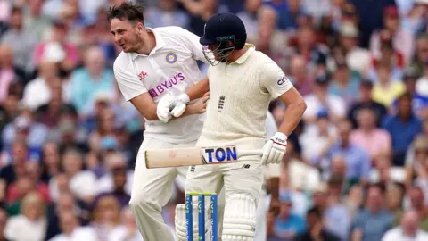 PA Media Daniel Jarvis collides with England batsman Jonny Bairstow