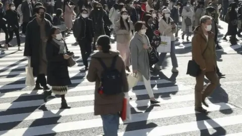 Reuters People walk on the streets of Tokyo, Japan. Photo: 26 December 2020