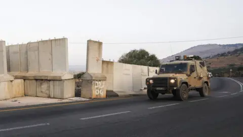 AFP An Israeli military vehicle patrols the border with Lebanon in the occupied Golan Heights (26 August 2019)