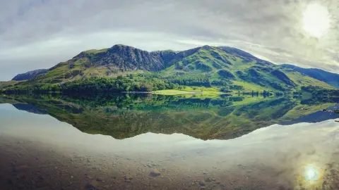 BBC/Duncan Leatherdale Mountains reflected on a lake