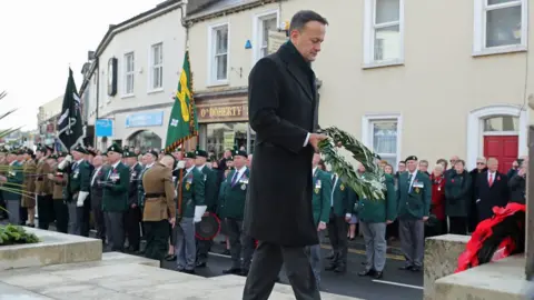 Niall Carson Taoiseach Leo Varadkar holds a wreath