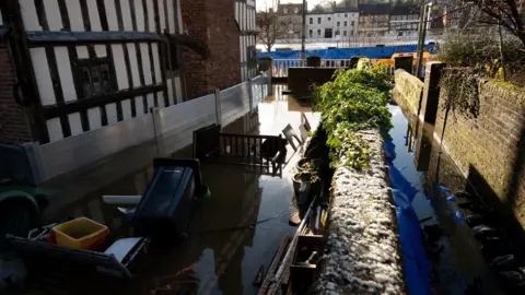 PA Media Water surrounds a riverside property in Bewdley, Worcestershire on Saturday