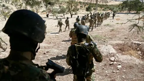 Getty Images Rebel fighters prepare for an attack by the Syrian government on Idlib province, on 3 September, 2018