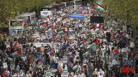 PA Media People take part in a pro-Palestine march in central London on 13 April