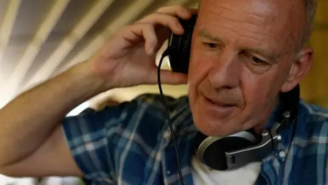 Fatboy Slim listening to headphones