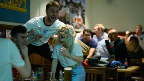 Getty Images England fans celebrating in a pub