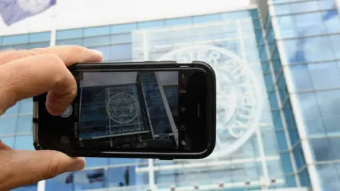 Ross Kinnaird A phone takes a picture at the stadium