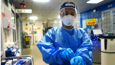 PA Media A medical worker wearing PPE at King's College Hospital, London