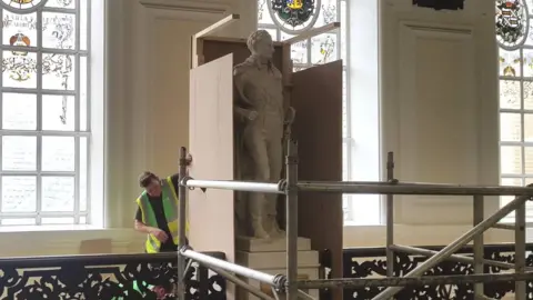 Alex Seabrook Workman boxing off Sir Thomas Picton statue at Cardiff City Hall