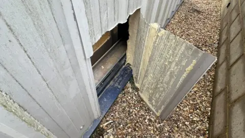 Steve Heathcock Hole in wall in cycle shop