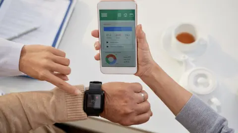 Getty Images Smartphone app linking to health monitoring watch