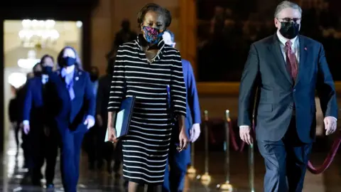 Getty Images Impeachment managers deliver articles to the Senate on 25 January