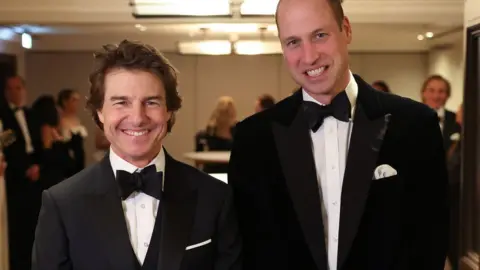 PA Media Tom Cruise standing alongside Prince William