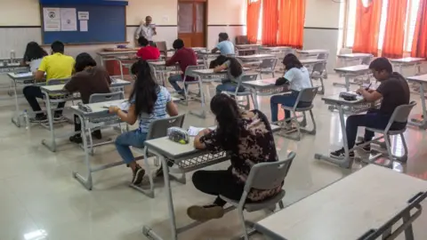 Getty Images A teacher takes a class of the students as schools in Maharashtra reopen after being shut for over a year-and-a-half in the wake of the Covid-19 pandemic, on October 4, 2021 in Mumbai, India.