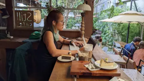 BBC Vietnamese Tram Nguyen in a local coffee shop