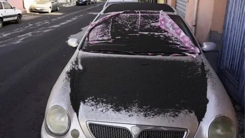 Reuters A car is covered in volcanic ashes from Mount Etna in Santa Venerina, Italy, 28 February 2021