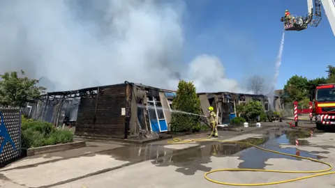 DFRS Firefighters putting out flames