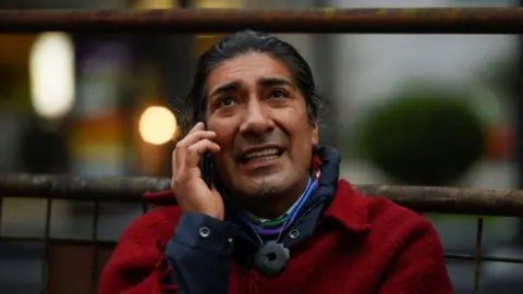 Reuters Yaku Perez speaks on a mobile phone outside a hotel, in Quito, Ecuador February 8, 2021.