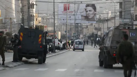 EPA Israeli forces are deployed at the scene of an attack that killed two Israeli settlers in Hawara, in the occupied West Bank, (26 February 2023)