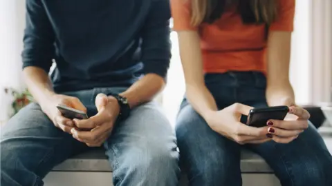 Getty Images 2 young people on phones