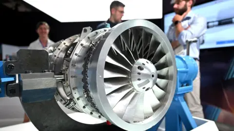 Getty Images Attendees look at a model of a Rolls Royce aircraft engine, created for the the proposed jet fighter aircraft Tempest