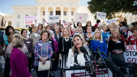 Getty Images Kayla Moore, wife of Roy Moore, speaks during a rally in support of her husband in front of the Alabama State Capitol