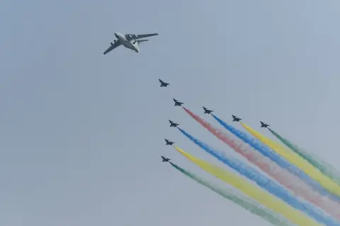 AFP A formation of military aircraft fly over Beijing during the military parade.