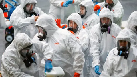 Reuters Members of a Servpro cleaning put on protective gear before entering the Life Care Centre of Kirkland, a long-term care facility linked to several confirmed coronavirus cases, in Kirkland, Washington, U.S