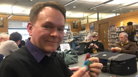 Steve Silk Mark Mander holding knitting needles