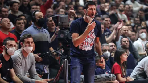 Getty Images Djokovic at basketball game