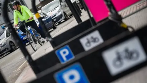 Getty Images A cyclist by some bike stands