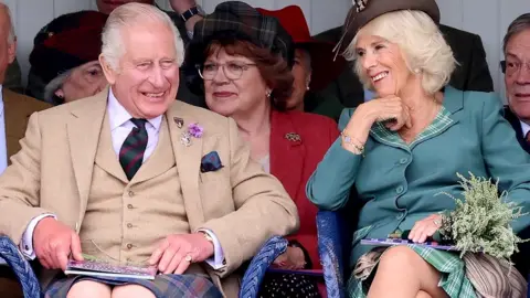 Getty Images King Charles III (wearing, for the first time, a kilt made from the new King Charles III tartan) and Queen Camilla attend The Braemar Gathering 2023