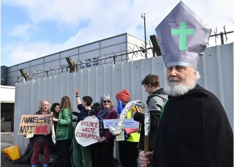 Pacemaker A protestor dressed as St Patrick outside the Thales plant near Belfast