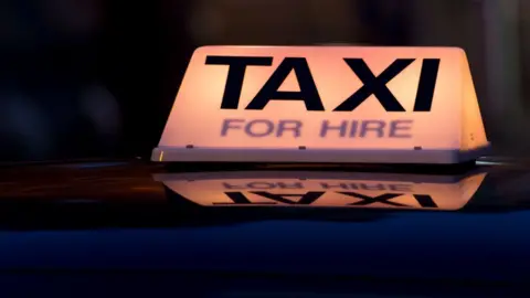 Getty Images A taxi for hire light on top of a taxi