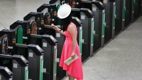 Reuters A woman enters a ticket gate for a train to Ascot at Waterloo Station in London, Britain June 22, 20