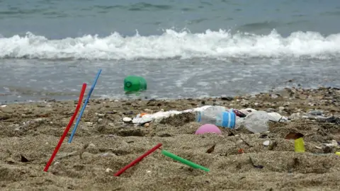 Getty Images Plastic rubbish lies on the Aegean sea beach near Athens